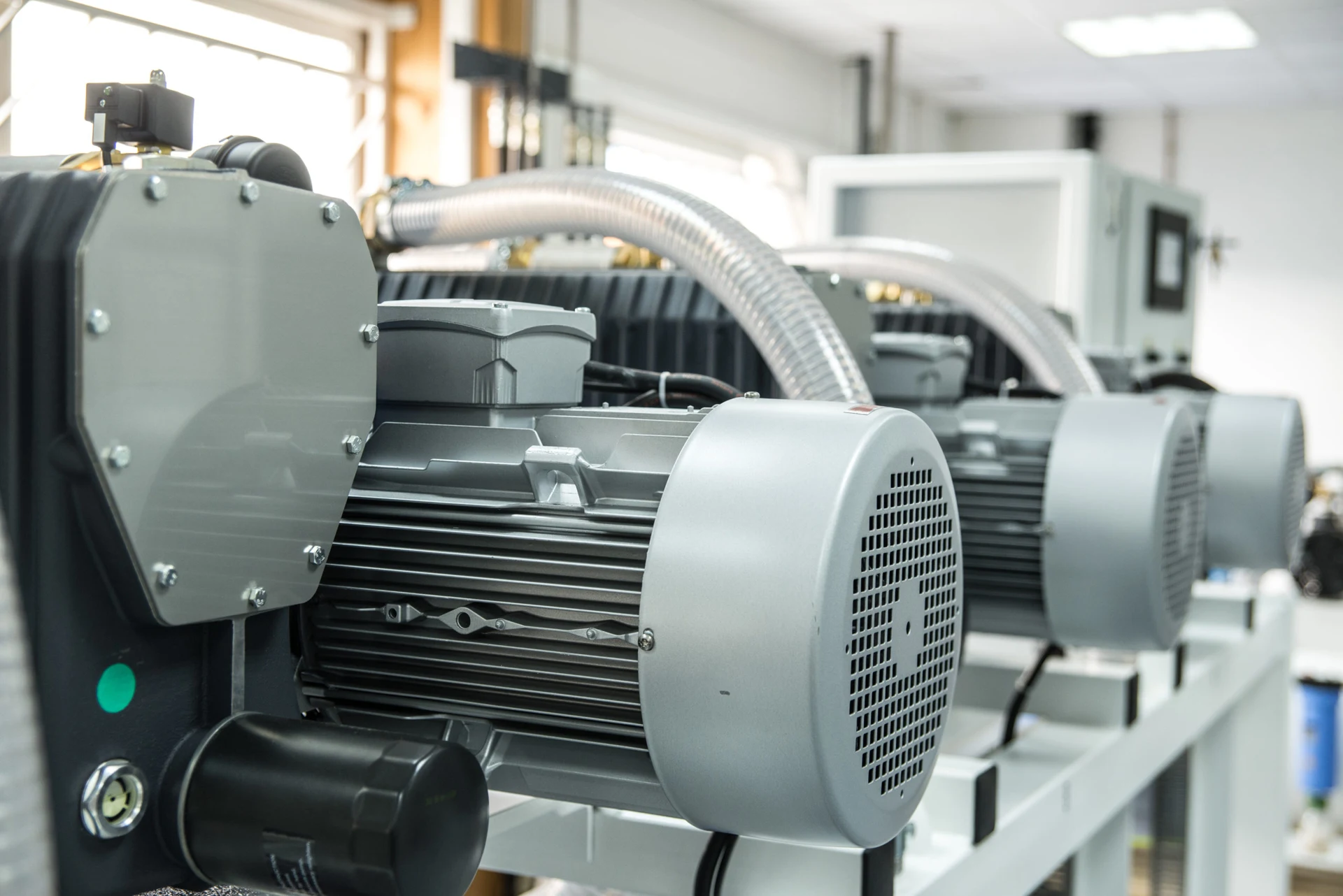 Industrial vacuum pump and motor assemblies